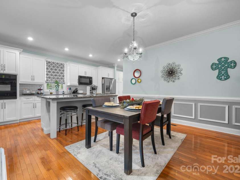 1246 Hillsboro Avenue, Hickory, NC 28602.  MLS# CAR4199854, YatesRealty ID 1745. Some updates in the Kitchen 2024!  Hardwood flooring, wainscoting, eat at island with sink.  Also, can lights are added as an upgrade too give you that glow!