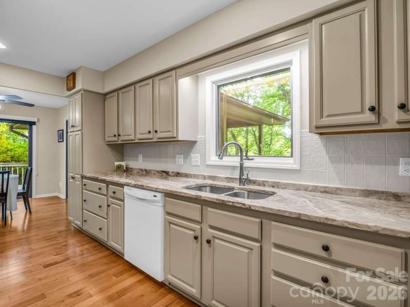 59 Agaliha Lane, Brevard, NC 28712.  MLS# CAR4392248, YatesRealty ID 1745. Generous counter space and a seamless flow directly into the dining area make this kitchen incredibly functional for everyday living.