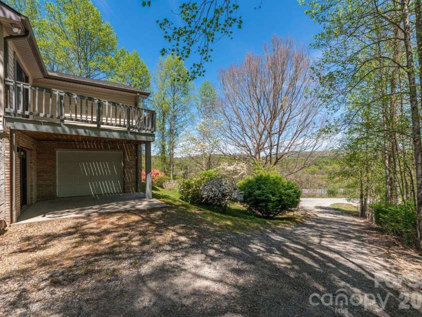 431 Pleasant Grove Road, Hendersonville, NC 28739.  MLS# CAR4368693, YatesRealty ID 17483. Side elevation overview deck off bedroom 2 lower garage