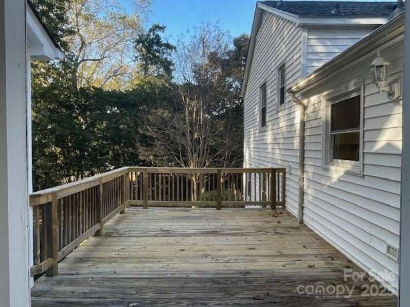 7608 Surreywood Place, Charlotte, NC 28270.  MLS# CAR4317171, YatesRealty ID 17485. Deck that is off of the screen porch and looks out over the back yard. There is a wall for the TV to watch your afternoon sports