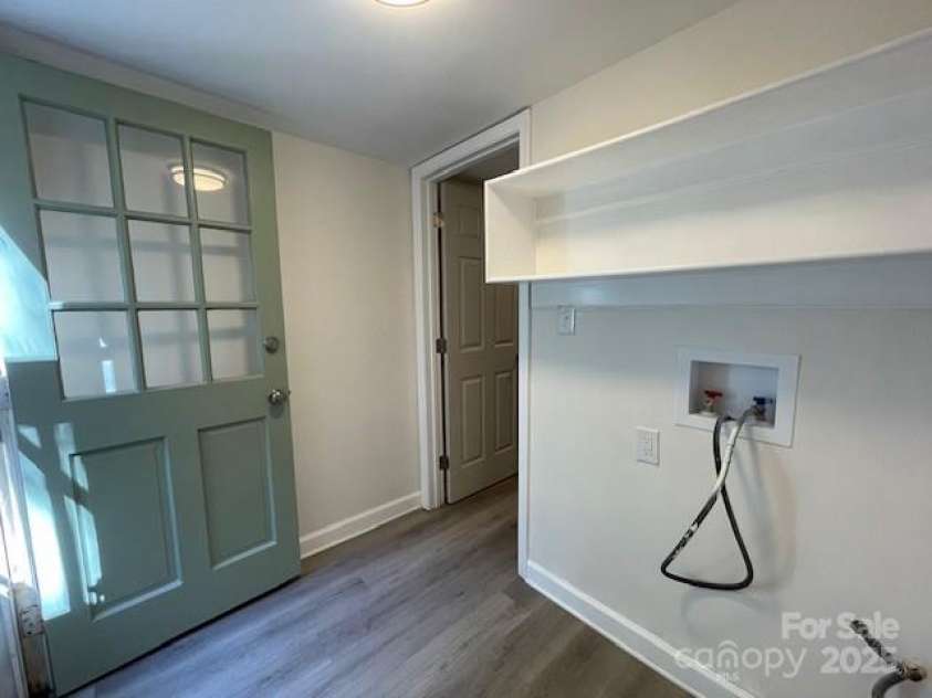7608 Surreywood Place, Charlotte, NC 28270.  MLS# CAR4317171, YatesRealty ID 17485. Laundry with LVP