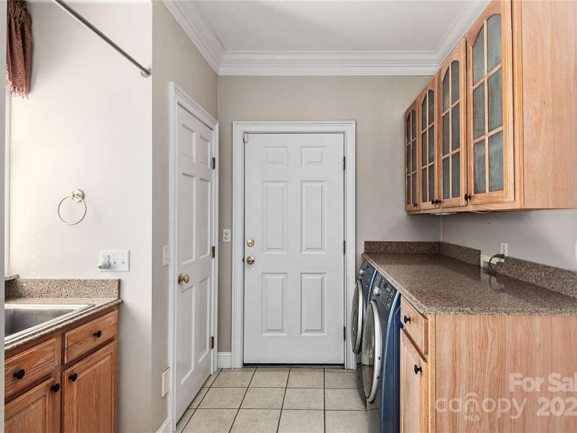 733 Hidden Hills Drive, Rutherfordton, NC 28139.  MLS# CAR4261137, YatesRealty ID 17489. Laundry room off of kitchen with stubbed-in toilet in closet.