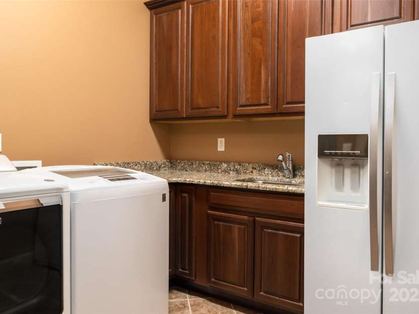 135 Sumter Drive, Mooresville, NC 28117.  MLS# CAR4252213, YatesRealty ID 17490. A main floor laundry room with utility sink, and room for a second fridge.