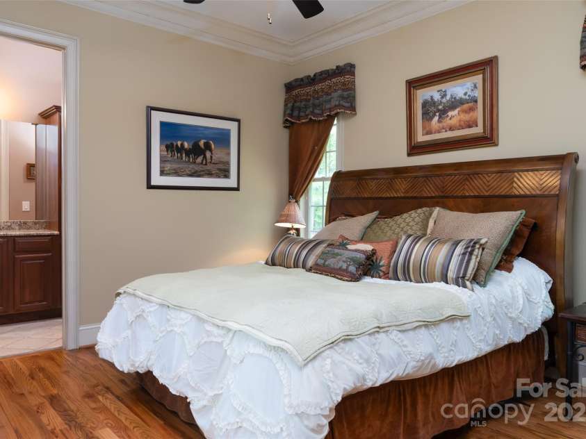 135 Sumter Drive, Mooresville, NC 28117.  MLS# CAR4252213, YatesRealty ID 17490. A second main level bedroom with ensuite is split from the primary for added privacy. Your guests will be delighted.