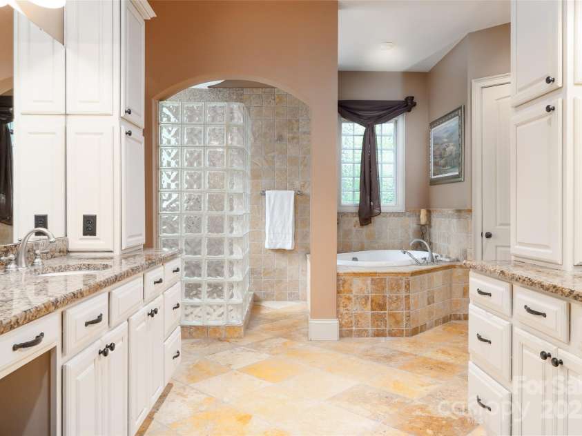 135 Sumter Drive, Mooresville, NC 28117.  MLS# CAR4252213, YatesRealty ID 17490. A spa like ensuite with open walk in shower, jetted tub and huge his/her vanities.