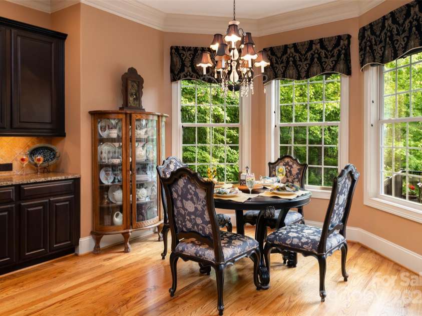 135 Sumter Drive, Mooresville, NC 28117.  MLS# CAR4252213, YatesRealty ID 17490. Enjoy your casual dining overlooking the serenity of the private backyard, pool, and lake.