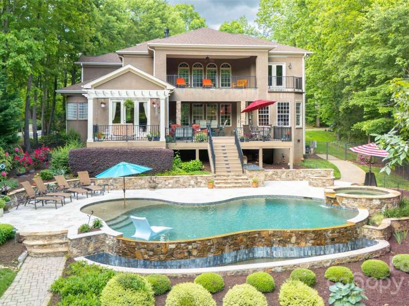 135 Sumter Drive, Mooresville, NC 28117.  MLS# CAR4252213, YatesRealty ID 17490. Imagine relaxing your cares away in your lakeside, saltwater infinity pool and spa.