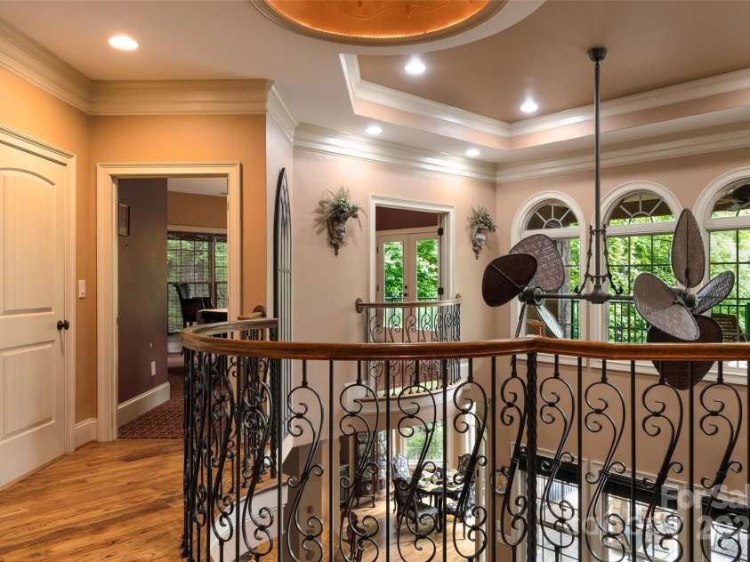 135 Sumter Drive, Mooresville, NC 28117.  MLS# CAR4252213, YatesRealty ID 17490. The artisan rails overlook the great room below and out on to the upper veranda.