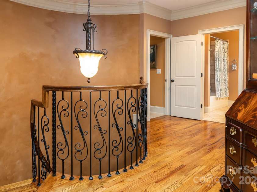 135 Sumter Drive, Mooresville, NC 28117.  MLS# CAR4252213, YatesRealty ID 17490. The spiral staircase brings you upstairs to this landing.