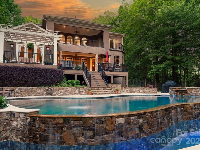 135 Sumter Drive, Mooresville, NC 28117.  MLS# CAR4252213, YatesRealty ID 17490. Twilight is a beautiful time of day to enjoy the outdoors at the luxurious retreat.