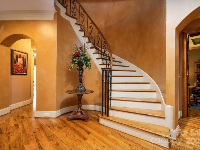 135 Sumter Drive, Mooresville, NC 28117.  MLS# CAR4252213, YatesRealty ID 17490. You are greeted by a winding architectural staircase accented with artisan railings.