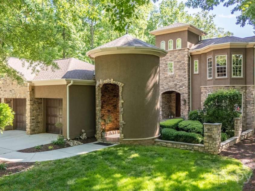 135 Sumter Drive, Mooresville, NC 28117.  MLS# CAR4252213, YatesRealty ID 17490. Your guests will enter your lakefront, tuscan villa through a beautiful stone waterfall. Every care melts away as you walk through this peaceful water feature.