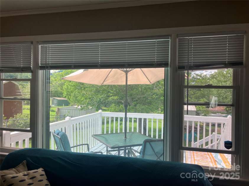407 Valley View Circle, Waynesville, NC 28786.  MLS# CAR4259161, YatesRealty ID 17492. Living room opens to amazing deck and backyard