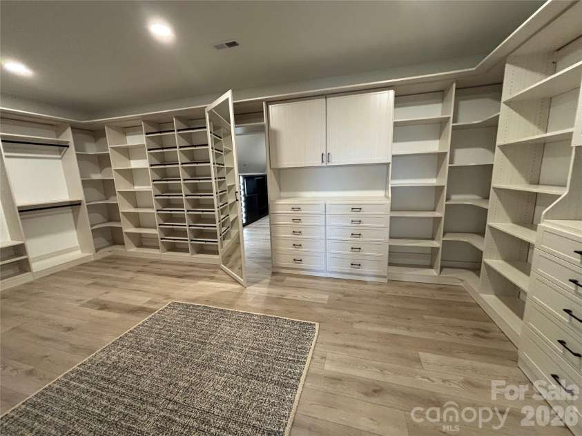 1027 Cox Road, Weddington, NC 28104.  MLS# CAR4299794, YatesRealty ID 17496. Custom primary closet with hidden back closet