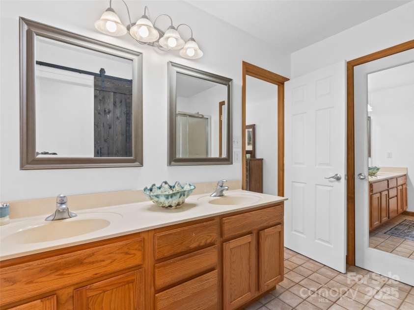 575 Upper Glady Fork Road, Candler, NC 28715.  MLS# CAR4258115, YatesRealty ID 17496. Ensuite bathroom off of primary bedroom
