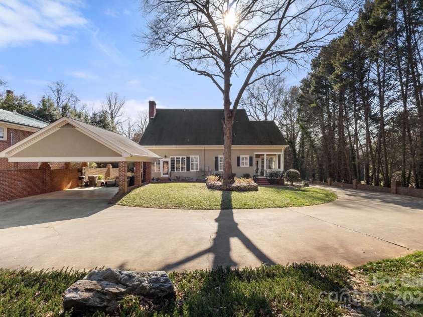 1335 Marion Street, Shelby, NC 28150.  MLS# CAR4220085, YatesRealty ID 17505. View of the carport, driveway, and back yard