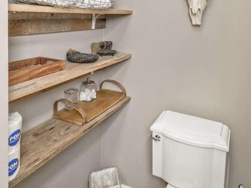 28 Mountain Vista Drive, Asheville, NC 28804.  MLS# CAR4265677, YatesRealty ID 17517. Shelf space in the guest suite bathroom keeps the necessities just an arm's length away.