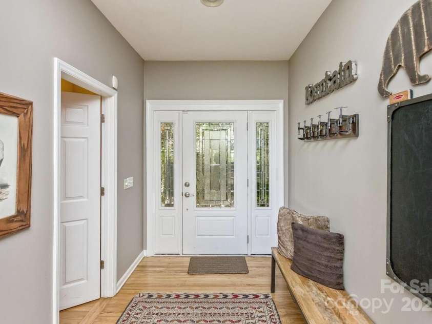 28 Mountain Vista Drive, Asheville, NC 28804.  MLS# CAR4265677, YatesRealty ID 17517. The entry foyer is generously proportioned with a half-bath just off the living room area.