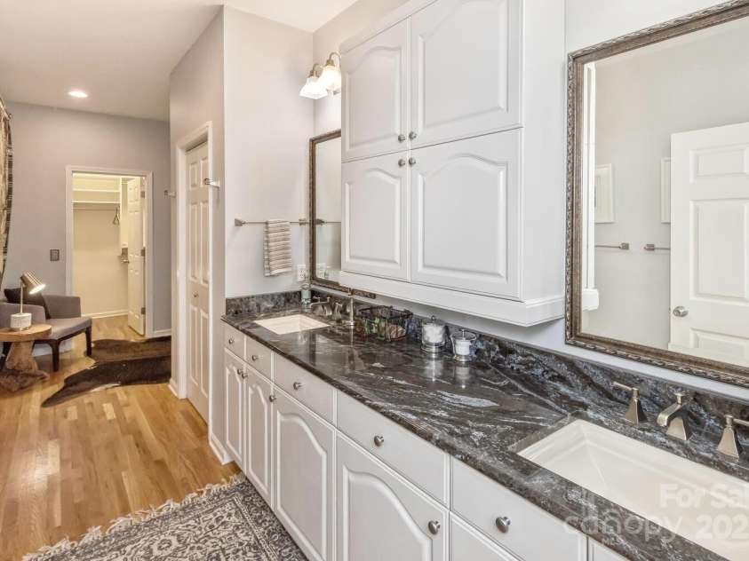 28 Mountain Vista Drive, Asheville, NC 28804.  MLS# CAR4265677, YatesRealty ID 17517. The primary bathroom vanity area is convenient, just steps from the primary bedroom area.