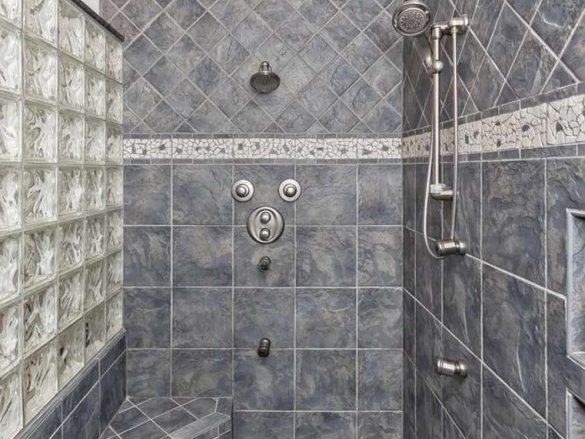 28 Mountain Vista Drive, Asheville, NC 28804.  MLS# CAR4265677, YatesRealty ID 17517. The primary bedroom shower is tiled and spacious.
