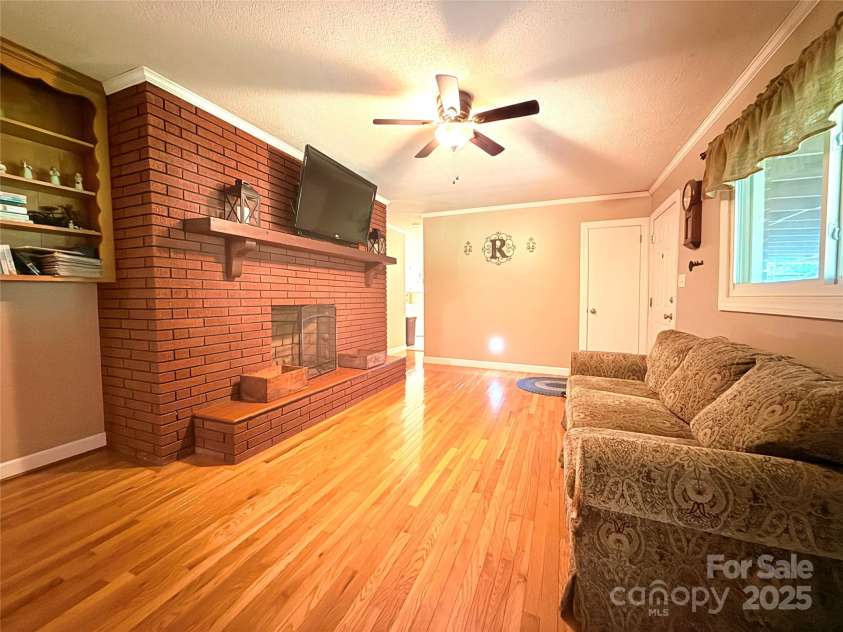 3158 Salisbury Highway, Statesville, NC 28677.  MLS# CAR4266177, YatesRealty ID 17524. Living room with large fireplace