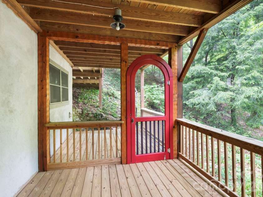 14 Weeping Cherry Forest Road, Fairview, NC 28730.  MLS# CAR4356619, YatesRealty ID 17536. Downstairs screened in porch