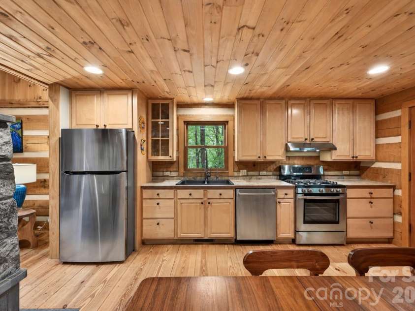 14 Weeping Cherry Forest Road, Fairview, NC 28730.  MLS# CAR4356619, YatesRealty ID 17536. Eat-in kitchen with stainless appliances and gas range.
