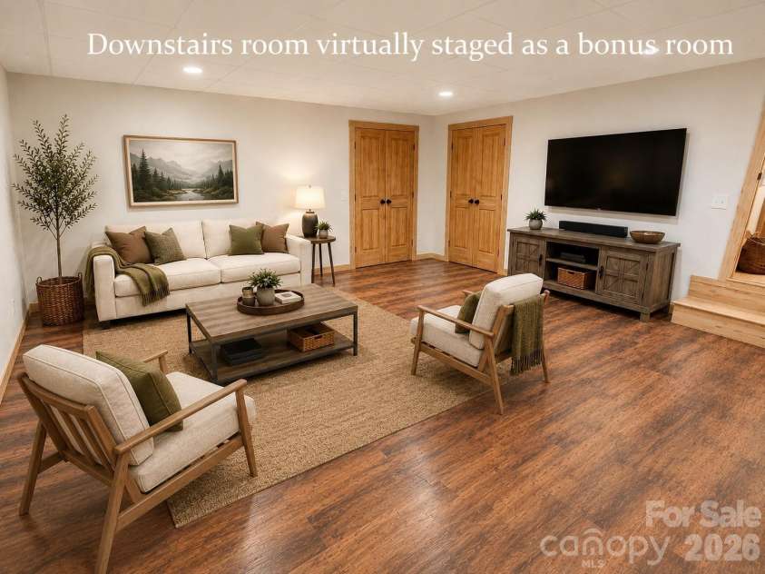 14 Weeping Cherry Forest Road, Fairview, NC 28730.  MLS# CAR4356619, YatesRealty ID 17536. Lower level bonus room/bedroom/home office with direct access to the expansive screened-in porch staged as a bonus room.