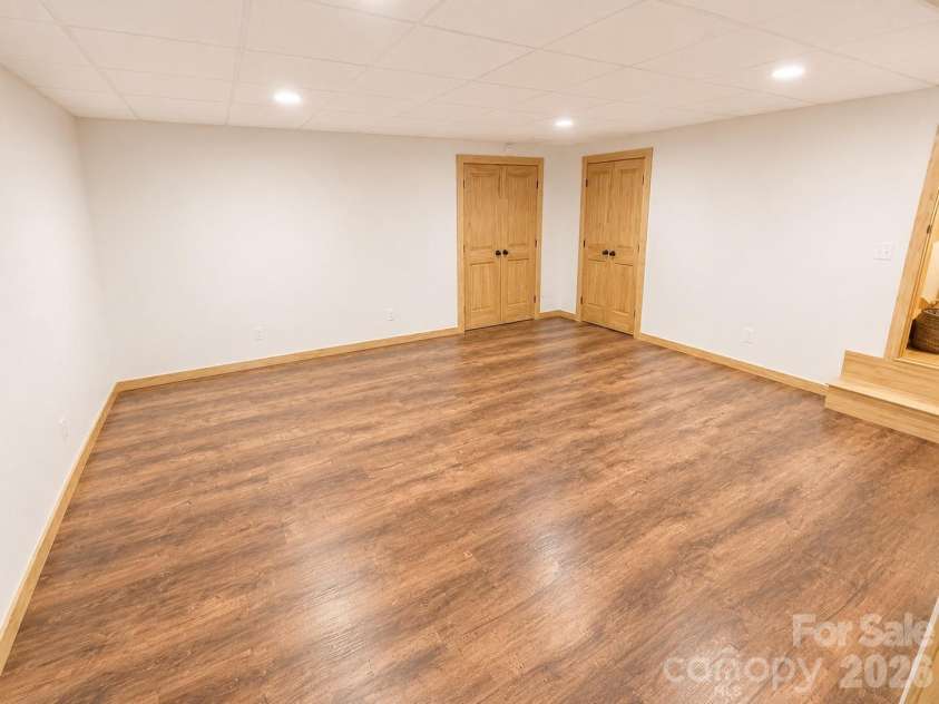 14 Weeping Cherry Forest Road, Fairview, NC 28730.  MLS# CAR4356619, YatesRealty ID 17536. Lower level bonus room/bedroom/home office with direct access to the expansive screened-in porch.