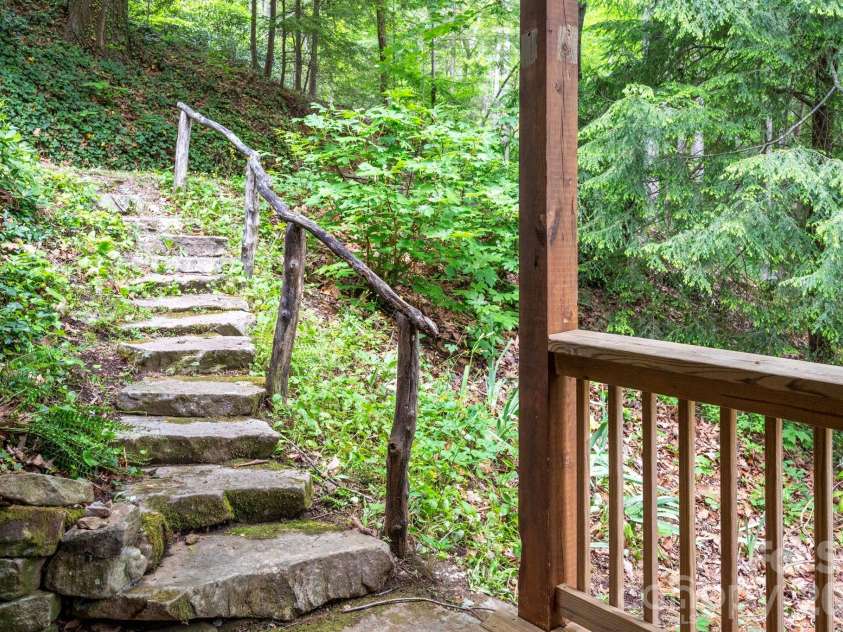 14 Weeping Cherry Forest Road, Fairview, NC 28730.  MLS# CAR4356619, YatesRealty ID 17536. Stone pathway from from drive to the lower level porch