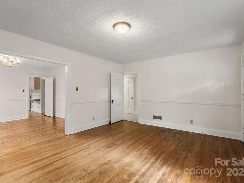 728 Blanton Street, Shelby, NC 28150.  MLS# CAR4274982, YatesRealty ID 1757. This view from the living room shows the dining room on the left and door to the hallway on the right.