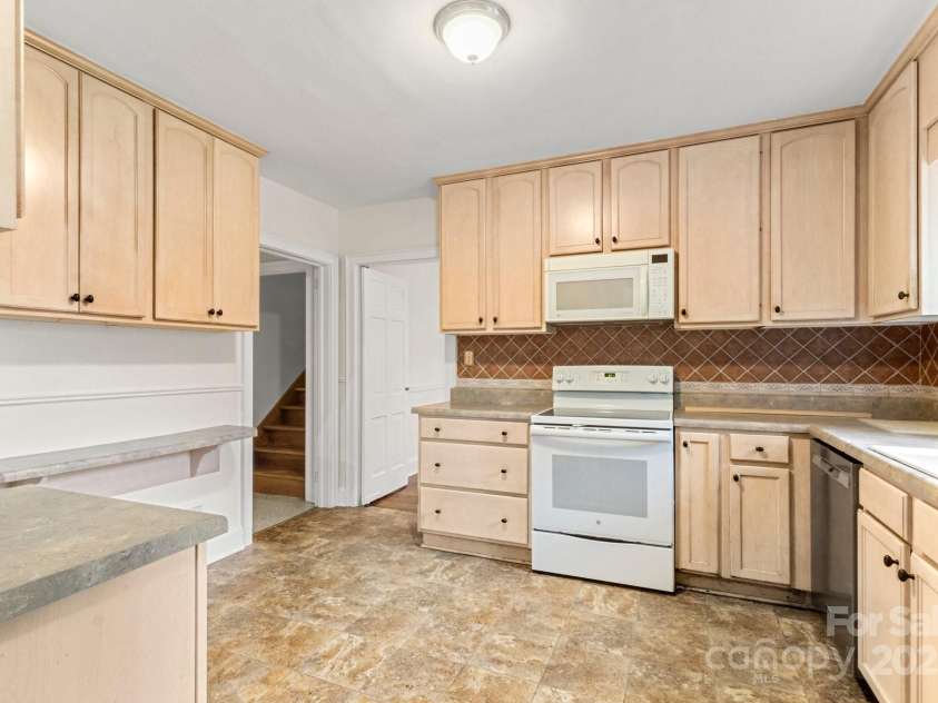 728 Blanton Street, Shelby, NC 28150.  MLS# CAR4274982, YatesRealty ID 1757. View from the laundry area to kitchen. There is ample counter space and to the left is a breakfast bar with room for seating.