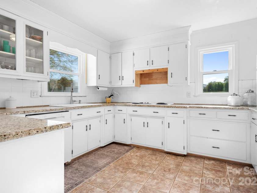 1235 Wilma Sigmon Road, Lincolnton, NC 28092.  MLS# CAR4238963, YatesRealty ID 17591. This kitchen has the ideal shape for those that love to cook with plenty of cabinet and counterspace plus lots of natural light.