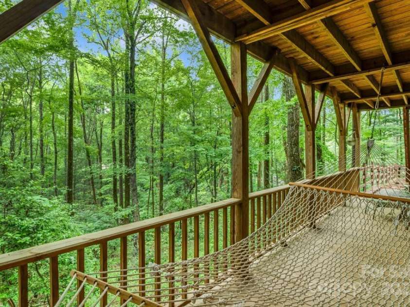 1501 Tanglewood Lane, Saluda, NC 28773.  MLS# CAR4266264, YatesRealty ID 17595. Lower level full length deck