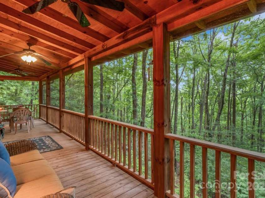 1501 Tanglewood Lane, Saluda, NC 28773.  MLS# CAR4266264, YatesRealty ID 17595. Main level screened in covered porch welcomes