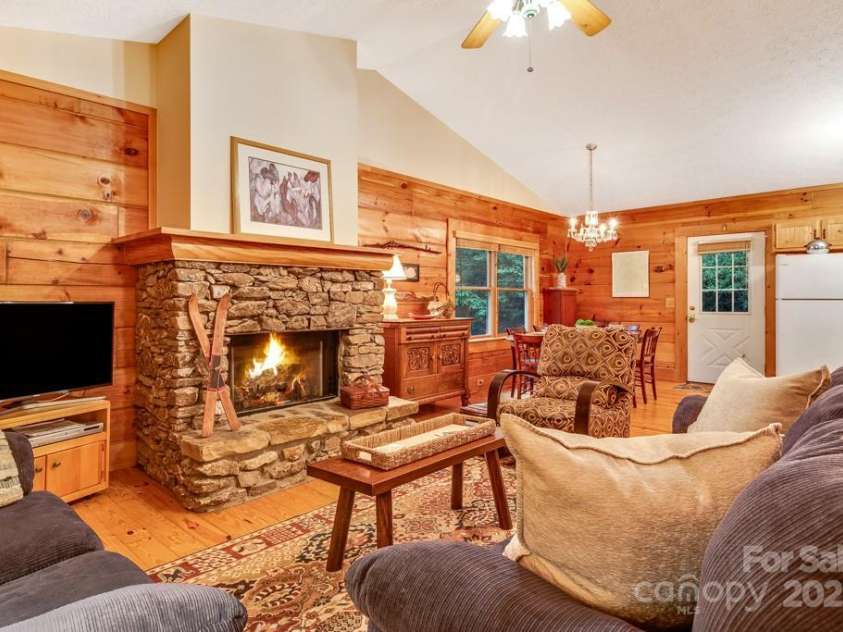 1501 Tanglewood Lane, Saluda, NC 28773.  MLS# CAR4266264, YatesRealty ID 17595. Stone fireplace enhances the natural feel