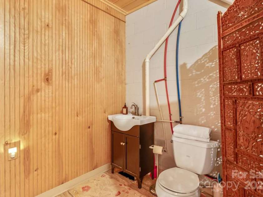 1501 Tanglewood Lane, Saluda, NC 28773.  MLS# CAR4266264, YatesRealty ID 17595. Unfinished 1/2 bath in lower level is ready for walls.