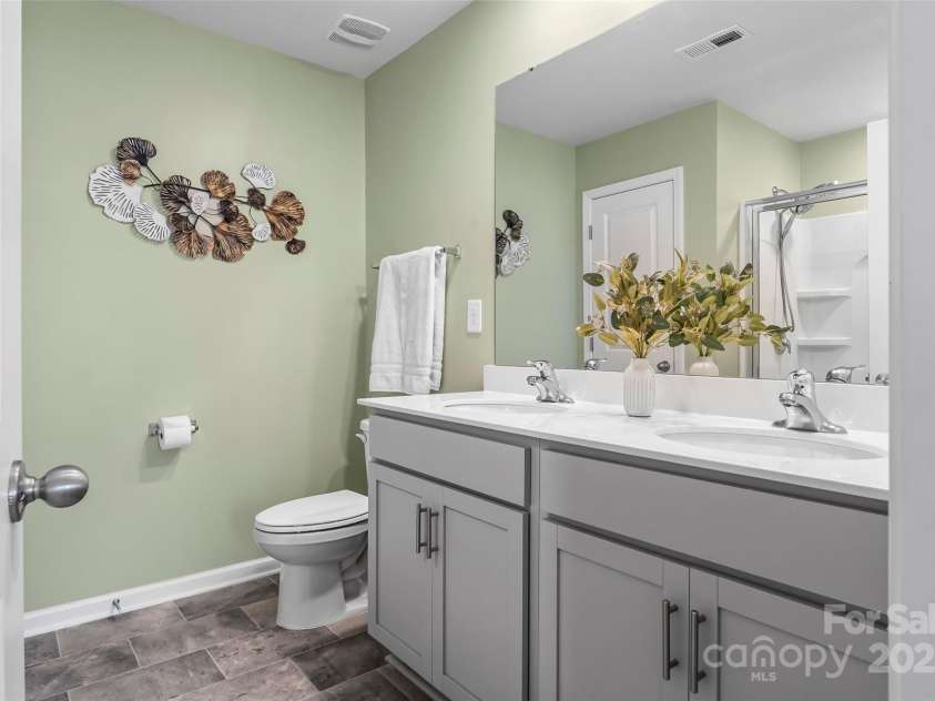 515 Benford Lane, Stanley, NC 28164.  MLS# CAR4265169, YatesRealty ID 17613. Primary ensuite bath has dual vanity sink, large walk-in shower and linen closet.