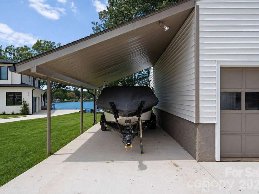 240 Shoreline Loop, Mooresville, NC 28117.  MLS# CAR4375040, YatesRealty ID 17619. Covered garage ideal for protecting watercraft and maximizing convenience for lakefront living