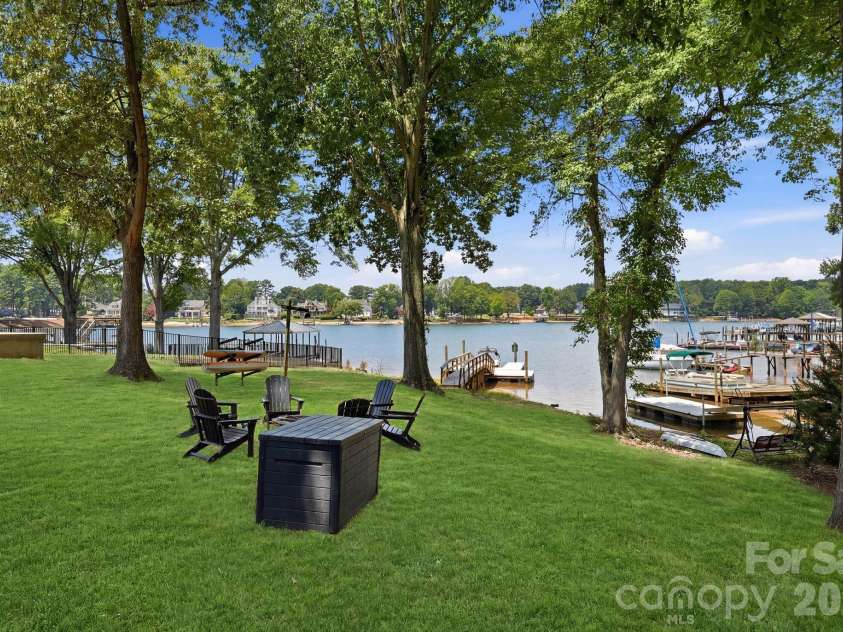 240 Shoreline Loop, Mooresville, NC 28117.  MLS# CAR4375040, YatesRealty ID 17619. Lakeside fire pit area surrounded by mature trees offering a private setting for entertaining and enjoying waterfront evenings