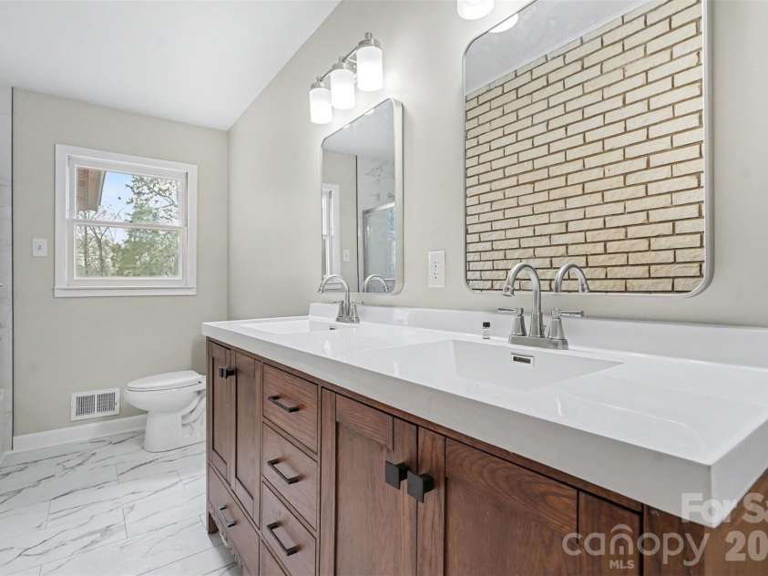 2401 Penninger Road, Concord, NC 28025.  MLS# CAR4344658, YatesRealty ID 1762. Renovated hall bath