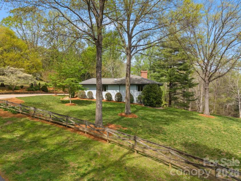 140 Meadowlark Drive, Tryon, NC 28782.  MLS# CAR4364731, YatesRealty ID 17628. Drone picture of side yard