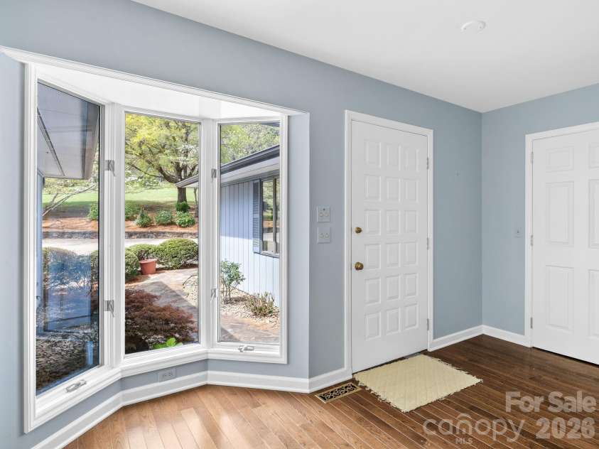 140 Meadowlark Drive, Tryon, NC 28782.  MLS# CAR4364731, YatesRealty ID 17628. Front door, coat closet, and bay window.