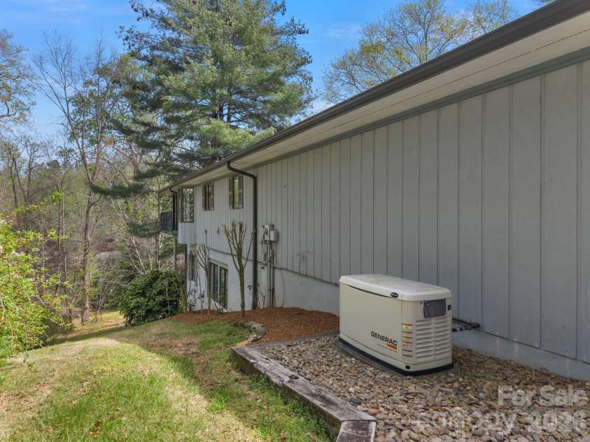 140 Meadowlark Drive, Tryon, NC 28782.  MLS# CAR4364731, YatesRealty ID 17628. Left side of home & Generac generator