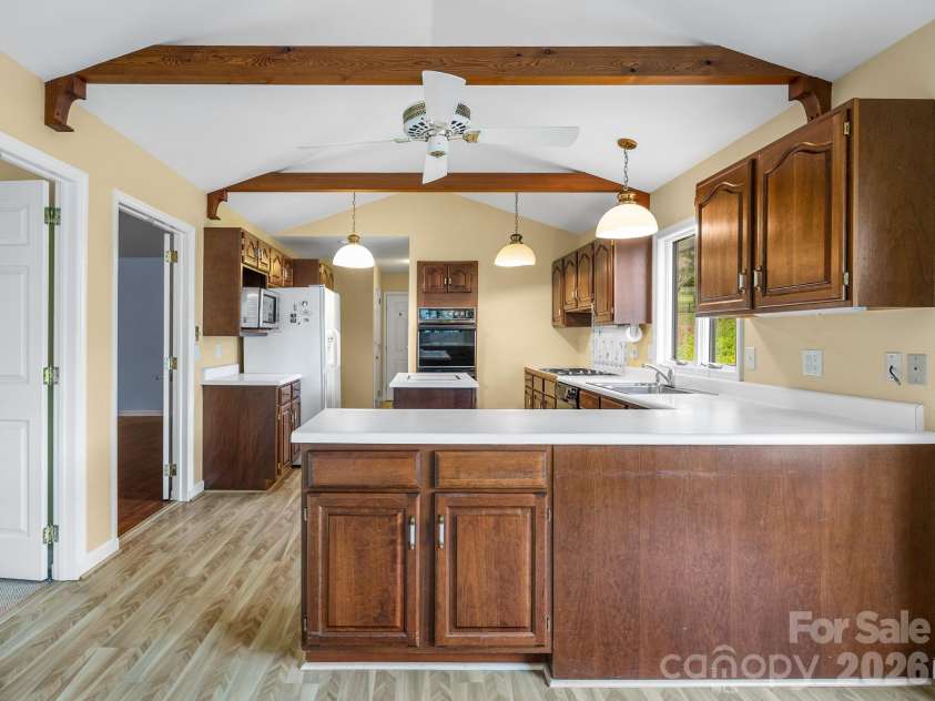140 Meadowlark Drive, Tryon, NC 28782.  MLS# CAR4364731, YatesRealty ID 17628. Spacious kitchen opens to great room and den