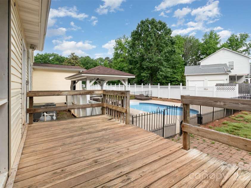 131 Scotland Drive, Mooresville, NC 28115.  MLS# CAR4254939, YatesRealty ID 17636. Deck off the laundry and screened porch