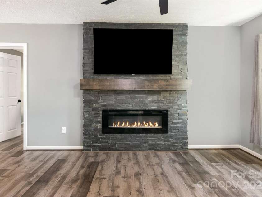 131 Scotland Drive, Mooresville, NC 28115.  MLS# CAR4254939, YatesRealty ID 17636. Family room fireplace