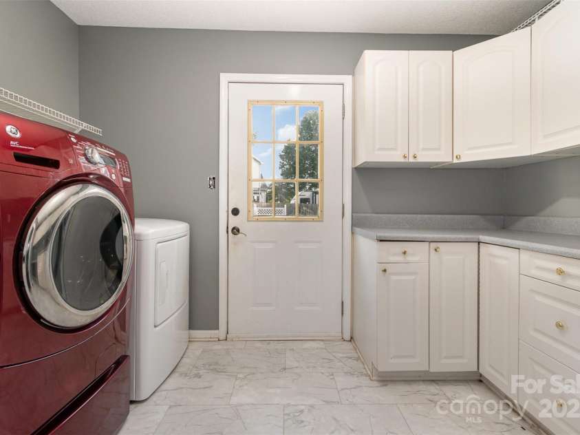 131 Scotland Drive, Mooresville, NC 28115.  MLS# CAR4254939, YatesRealty ID 17636. Large Laundry with storage and a door to the pool area