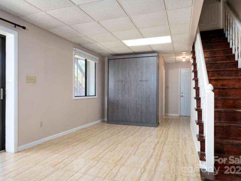 58 Braddock Way, Asheville, NC 28803.  MLS# CAR4246877, YatesRealty ID 17643. Basement Hallway with Murphy Bed