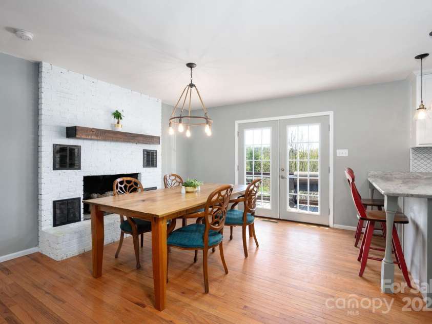 58 Braddock Way, Asheville, NC 28803.  MLS# CAR4246877, YatesRealty ID 17643. Dining Area with White Brick Fireplace